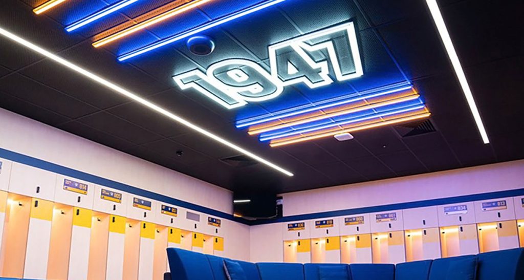 Parramatta Eels changing room with lights in blue and orange brand colours